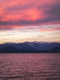 Scenic view of sea against dramatic sky during sunset