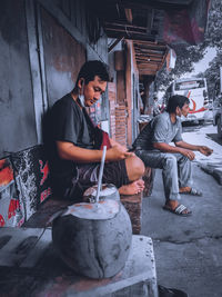 Man and woman standing against wall