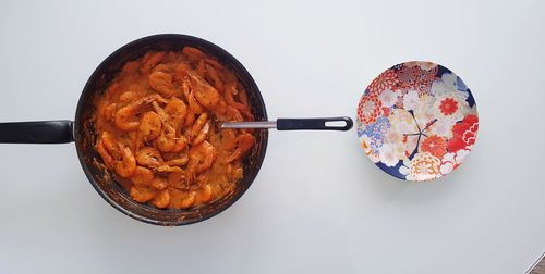 High angle view of breakfast on table against white background