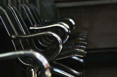 Empty metallic chairs in building