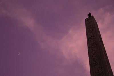 Low angle view of tower against cloudy sky