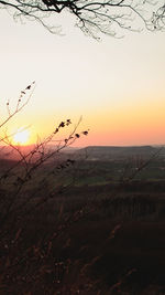 Scenic view of silhouette field against sky during sunset