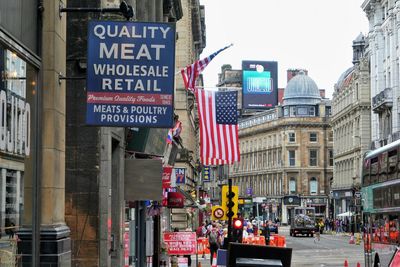 Information sign on road by buildings in city