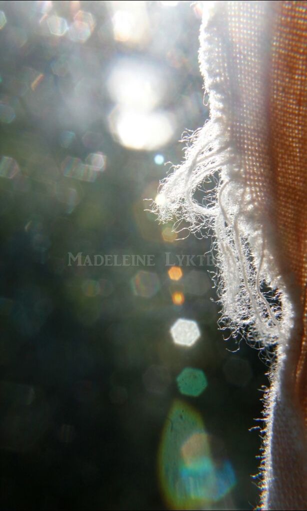 close-up, focus on foreground, lens flare, water, nature, no people, outdoors, text, cold temperature, sunlight, defocused, day, winter, reflection, selective focus, communication, part of, transparent, glass - material, western script