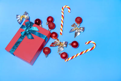 Low angle view of christmas tree against blue background