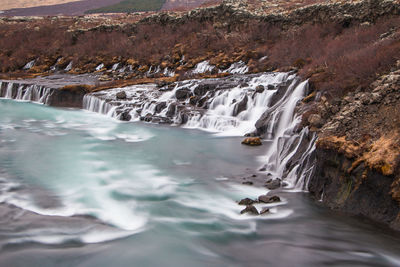 Aerial view of river flowing through rocks