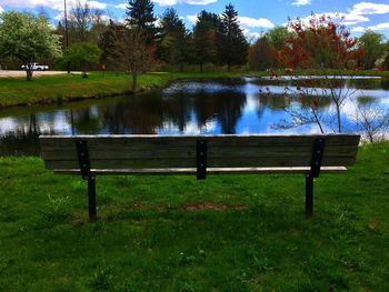 Scenic view of lake by trees against sky