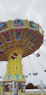 Low angle view of ferris wheel against sky