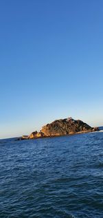 Scenic view of sea against clear blue sky