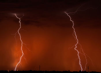 Low angle view of lightning against sky at night