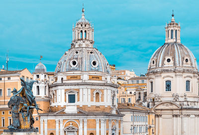 Historic buildings in city against sky