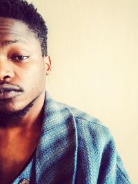 Portrait of young man against wall