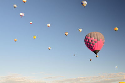 Low angle view of hot air balloons flying in sky