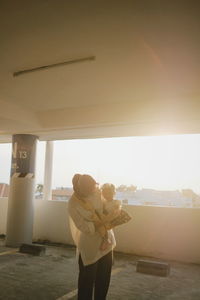 Rear view of couple standing against the sky