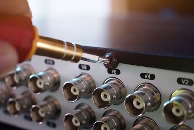 Close-up of hand repairing equipment