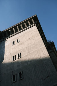 Low angle view of building against clear blue sky