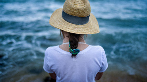 Rear view of woman standing against sea