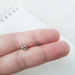 Close-up of hand holding ring over white background