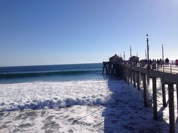 Scenic view of beach against clear blue sky