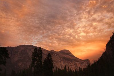 Scenic view of mountains against cloudy sky