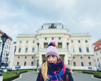 Portrait of woman standing in city during winter