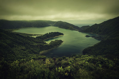 Scenic view of lake and mountains against sky