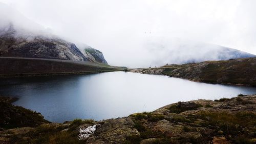 Scenic view of lake and mountains against sky