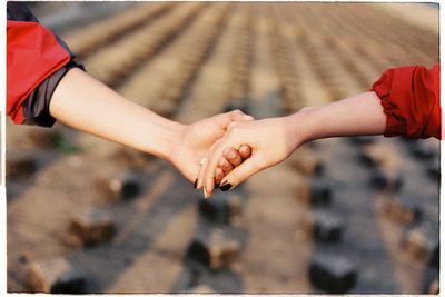 Midsection of man holding hands