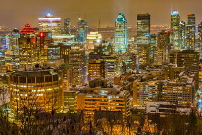 High angle view of illuminated buildings in city at night