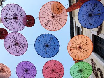 Low angle view of decoration hanging against blue sky