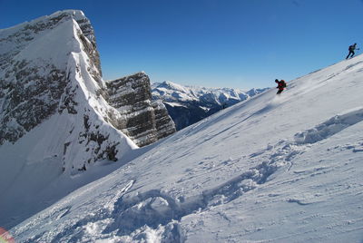 Scenic view of snowcapped mountains against clear sky