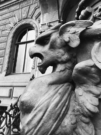 Low angle view of statue against building