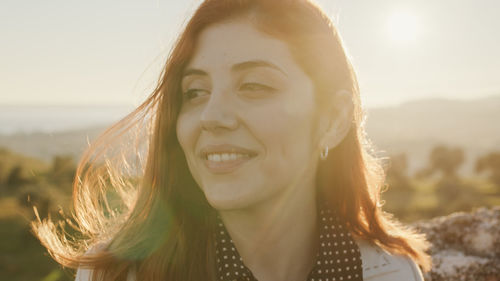 Beautiful girl with white dress explores an ancient italian castle at sunset