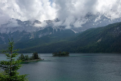 Scenic view of lake and mountains against sky