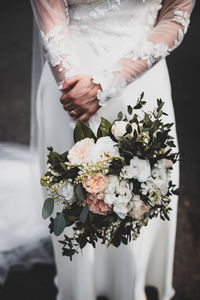 Midsection of woman holding bouquet