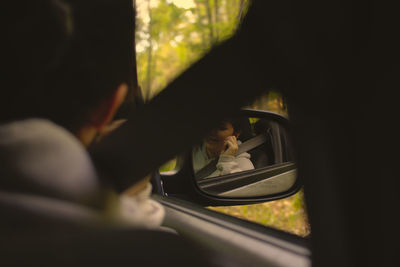 Reflection of man in car window