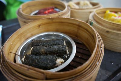 High angle view of dim sum in wooden bowl on table