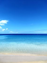 Scenic view of sea against blue sky