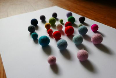 High angle view of multi colored wool balls on table