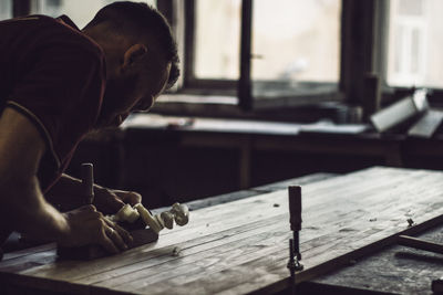 Man working on table at workshop