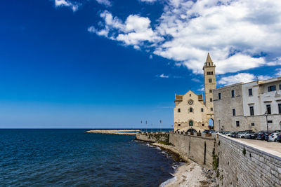 View of sea and buildings against sky