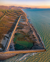 High angle view of sea shore against sky during sunset