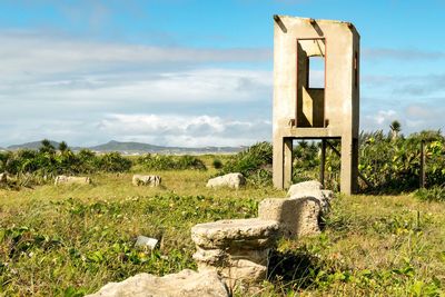 Built structure on grass against sky