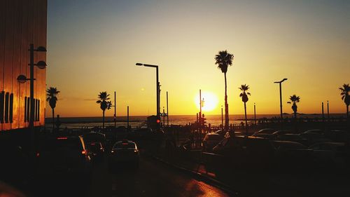 Traffic on road at sunset