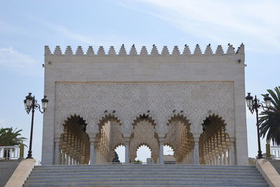 Low angle view of statues on building against sky