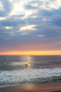 Scenic view of sea against sky at sunset