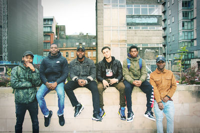 Group of people against buildings in city