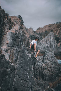 Rear view of man standing on rock formations