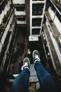 Low section of person sitting on apartment rooftop