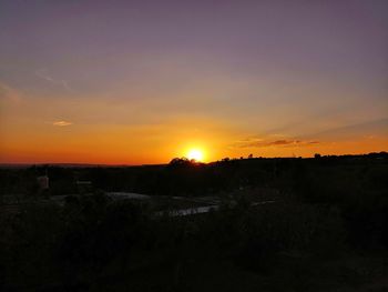 Silhouette landscape against sky during sunset